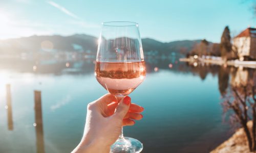 Female,Hand,With,Glass,Of,Wine.,Cozy,Pier,On,The